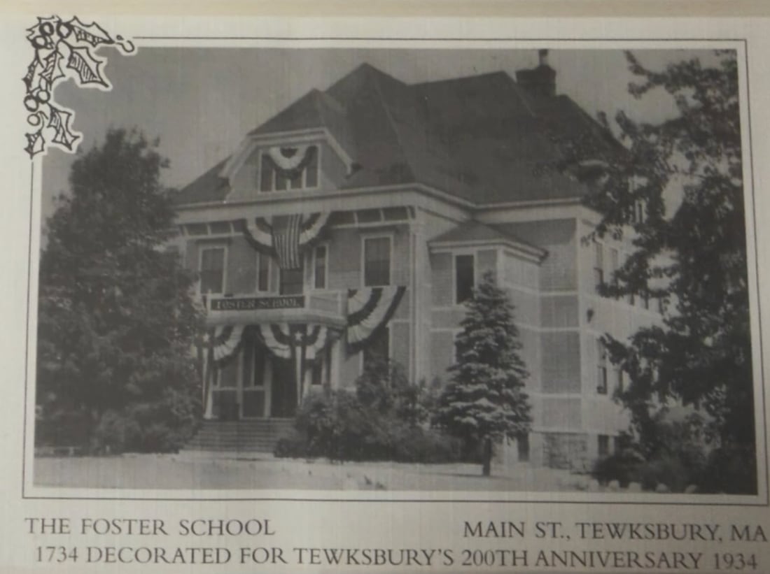 Black and white postcard of the Foster School on Main Street, Tewksbury, decorated with flags and bunting for the town’s 200th anniversary in 1934